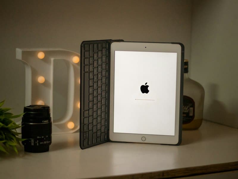 Silver iPad in a keyboard case on a shelf